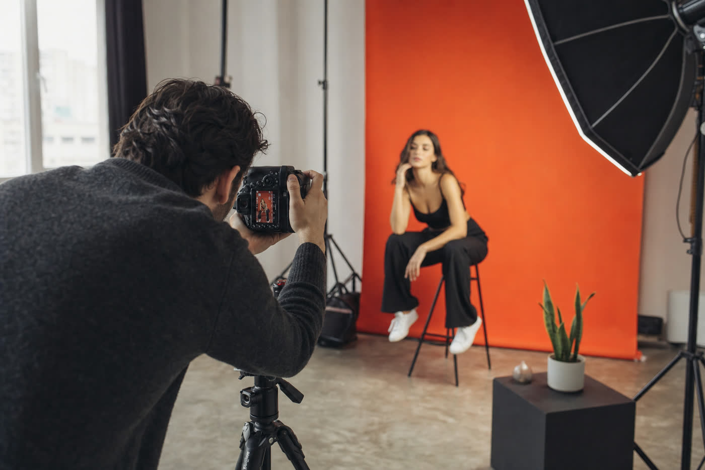 Behind‑the‑scenes of a Studio Ember content shoot with a photographer and model.